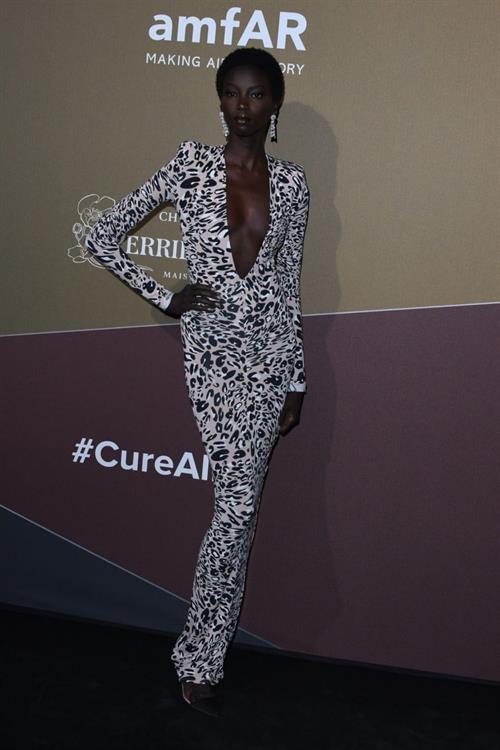 Anok Yai braless boobs in a low cut dress showing nice cleavage.
























































