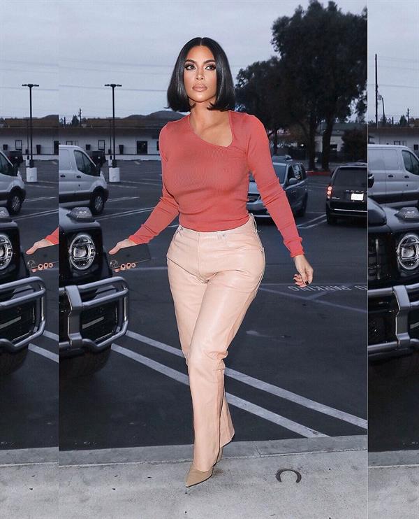Kim Kardashian braless boobs in a slightly see through top showing off her big tits.
