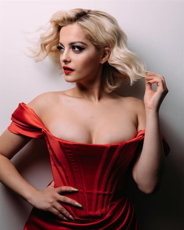 Bebe Rexha big boobs showing nice cleavage in a sexy little red dress.