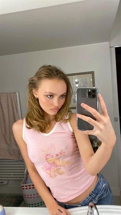 Lily-Rose Depp Selfie Pictures Lily-Rose Depp braless boobs in a slightly see through pink top showing off her tits pokies.
