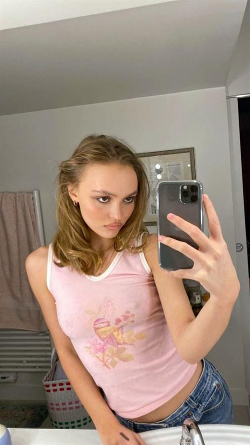 Lily-Rose Depp braless boobs in a slightly see through pink top showing off her tits pokies.