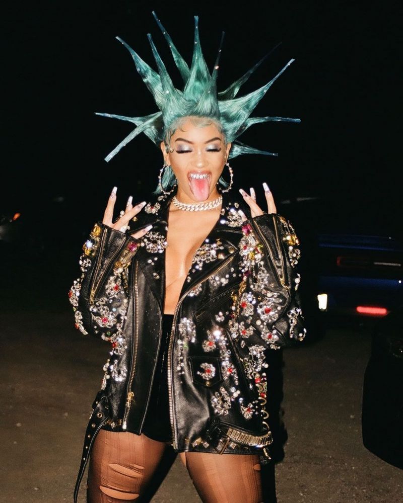 Saweetie braless boobs showing nice cleavage in just an open jacket showing off her tits.