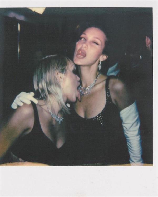 Miley Cyrus pictured kissing and licking model Bella Hadid's boobs at the Marc Jacobs fashion show.