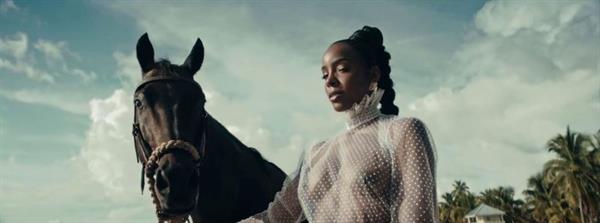 Kelly Rowland braless boobs in a totally see through dress showing off her big tits on a horse during her new music video for COFFEE.