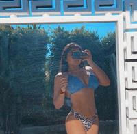 Alisha Sahi in a bikini taking a selfie