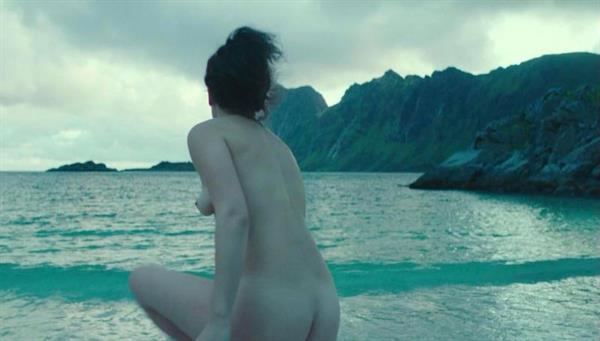 Jenny Slate nude scene screenshots showing her topless boobs and naked ass running into the water.