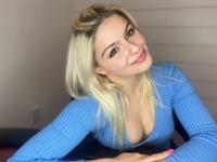 Ariel Winter boobs showing nice cleavage with her big tits leaning forward in a sexy blue top after getting vaccinated.