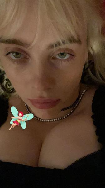 Billie Eilish boobs showing nice cleavage with her famous big tits up close.