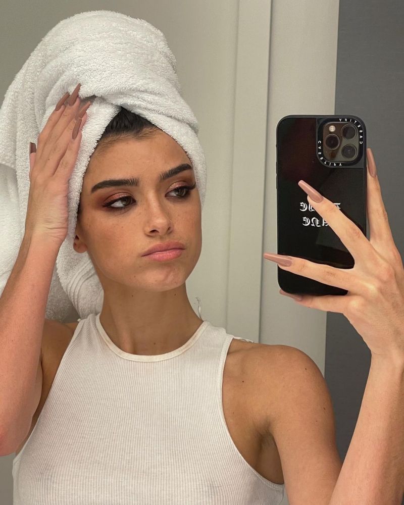 Dixie D’Amelio braless boobs in a see through white tank top showing off her big tits clearly showing her nipples.