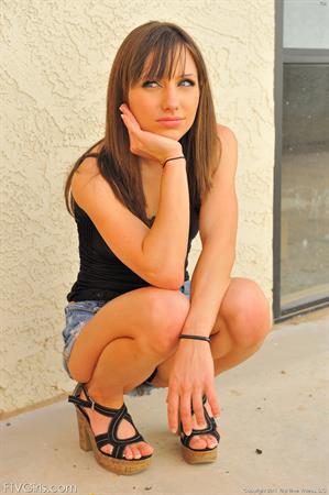 Risi FTV Nude Pictures Risi in a skirt and heels flashing outdoors