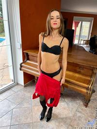 Dressed to impress in her hot red getup that clings to every one of her slim curves Little Renny looks almost good enough to eat. 