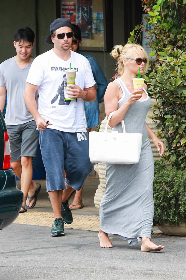 Pamela Anderson leaves barefoot a local Restaurant with a friend in Malibu July 6, 2013 