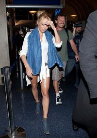 Pamela Anderson shows some legs at Los Angeles International Airport on February 20, 2013